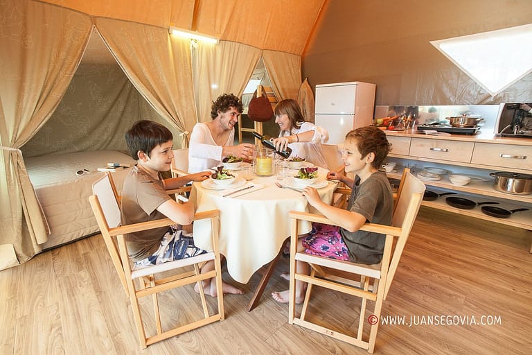 Familia con ninos comiendo en un bungalow del camping Torre de La Mora de Tarragona