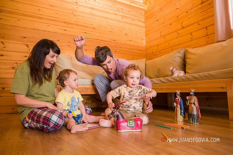 Familia con ninos jugando en el comedor de un bungalow del camping de Prades