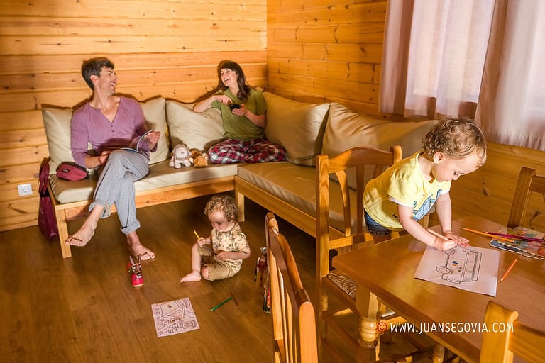 Familia con ninosen el comedor de un bungalow del camping de Prades